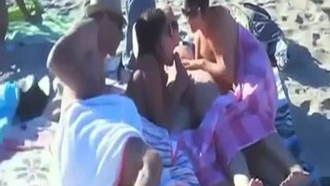 Deux couples font l'amour en public sur une plage